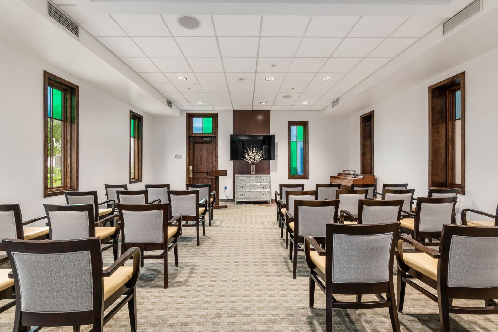 Community room with chairs and a television in a senior living facility in Lewis Center, Ohio.