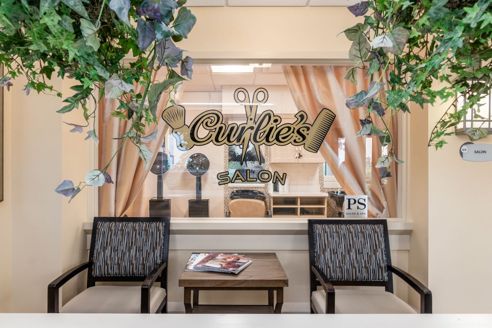 Curlies Salon with chairs and table in the lobby of a senior living community.