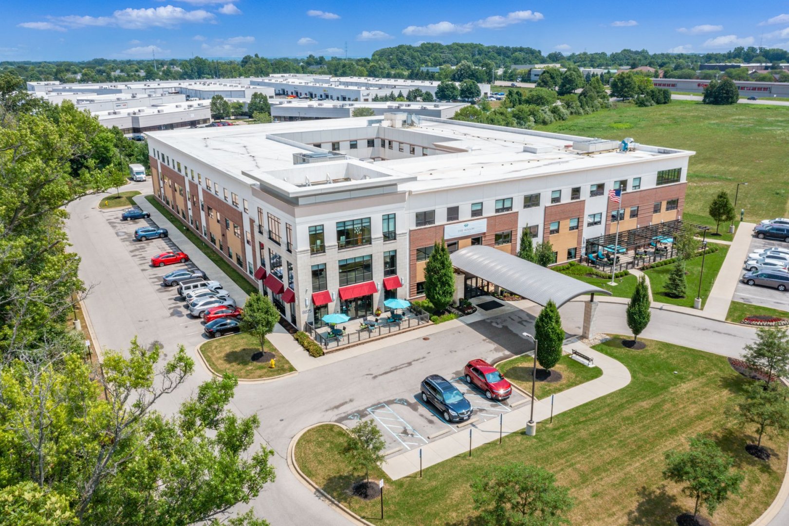 Aerial view of a senior living community in Lewis Center, Ohio with parking and garden areas.