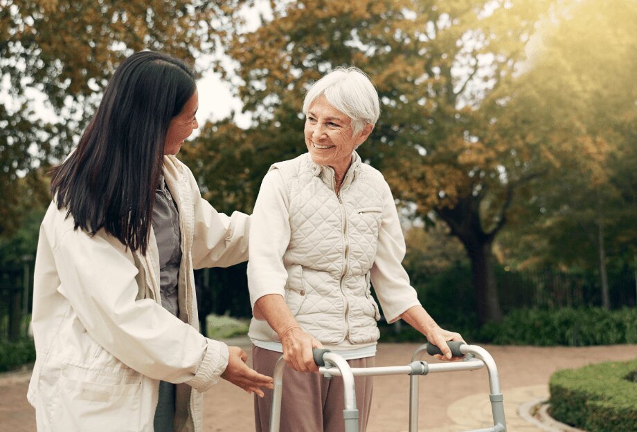nurse-with-senior (1) Nurse helping senior woman walk with her walker