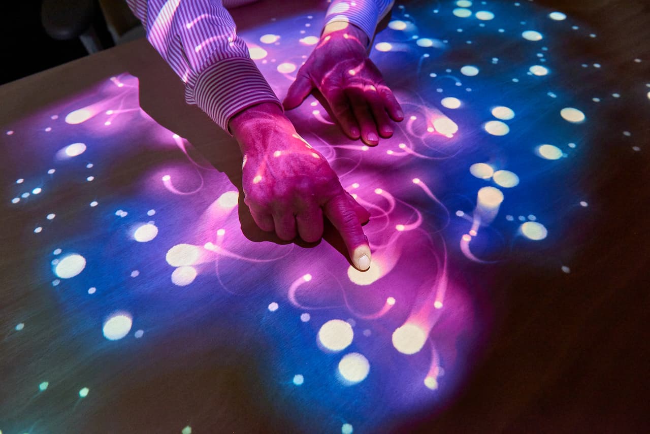 senior woman playing in tovertafel lights